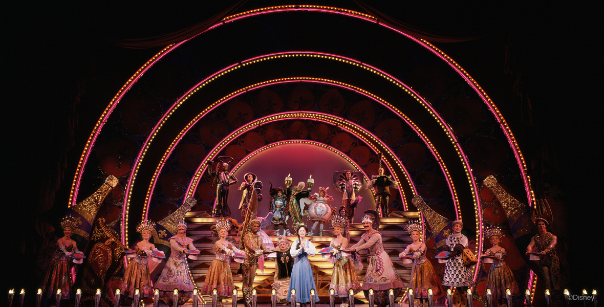 Photograph of the cast on stage performing the “Be Our Guest” musical number.