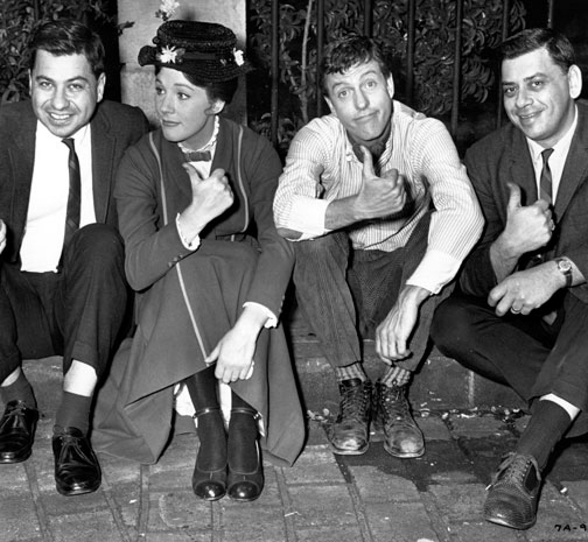 Richard M. Sherman, Julie Andrews, Dick Van Dyke, and Robert B. Sherman each give a thumbs up on the set of Mary Poppins.