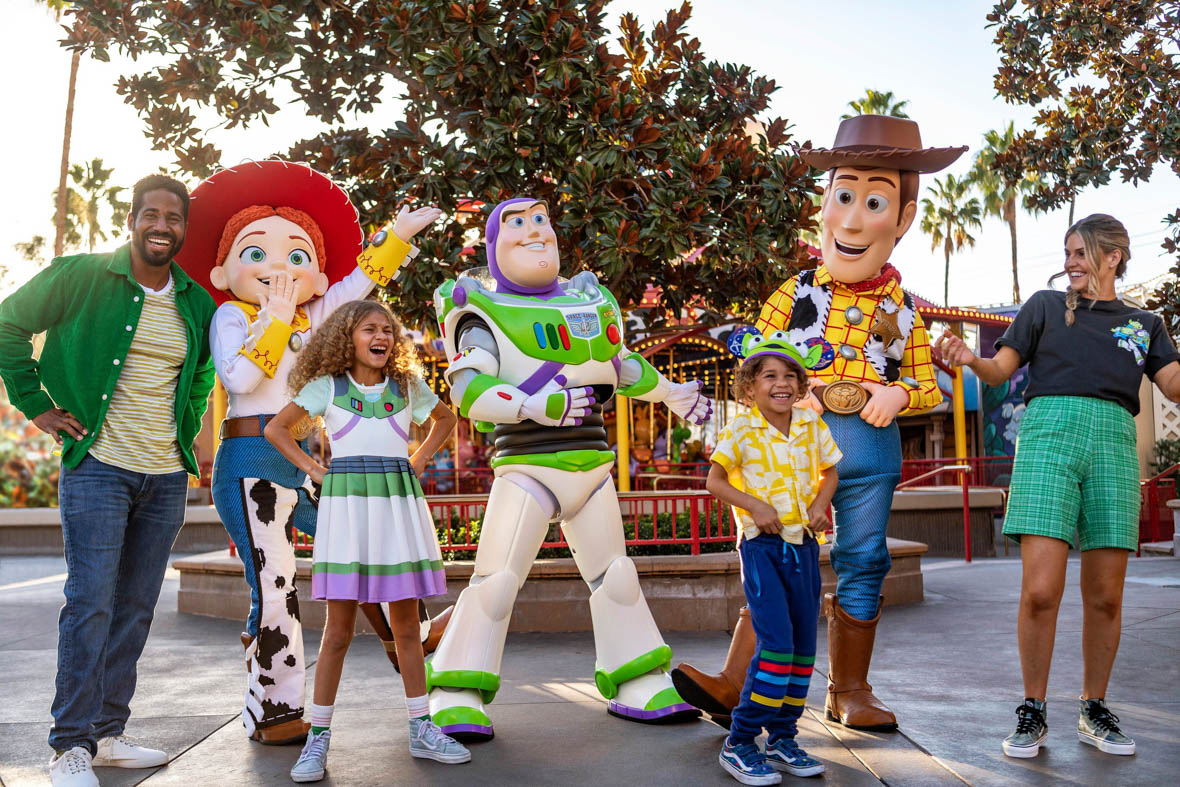 Guests posing with Jessie, Buzz Lightyear, and Woody at Disneyland Resort