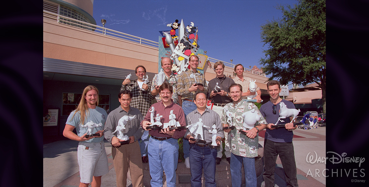 Animators of Mulan (1998) holding maquettes from the film outside of The Magic of Disney Animation attraction at Disney-MGM Studios.