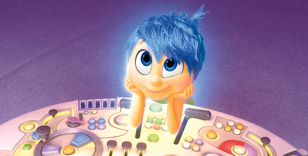 In a scene from Inside Out, Joy (voiced by Amy Poehler) is leaning on a large, pink controller with colorful buttons and levers. Joy is subtly glowing, and has short, blue hair. She rests on her elbows, palms cupping her face. The room’s floor is purple.