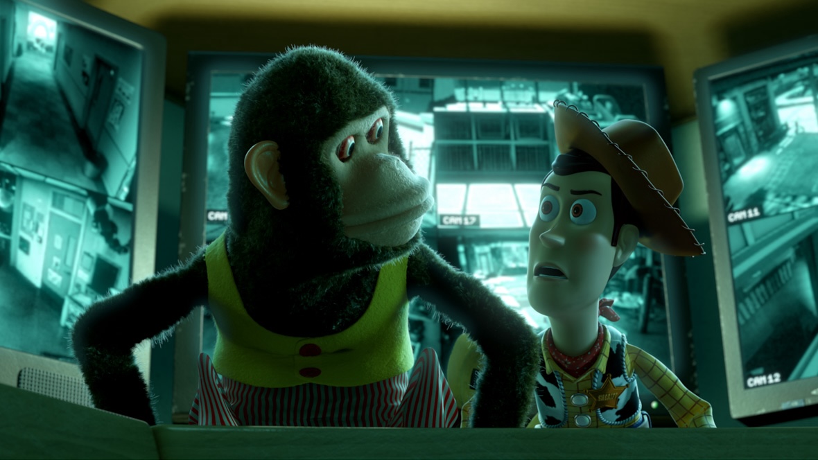 With three different security monitors, each with four camera feeds, The Monkey from Toy Story 3 looks at Woody who appears to be concerned.
