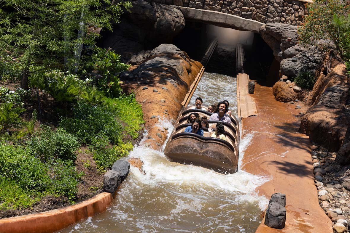 Guests ride a log flume in Tiana's Bayou Adventure at Walt Disney World Resort.