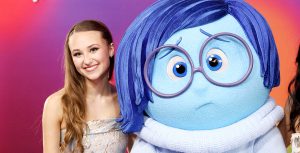 Inside Out 2 cast member Maya Hawke stands next to the character Sadness at the film’s world premiere at the El Capitan Theatre in Hollywood, California, on June 10. She’s wearing a shimmering silver gown.