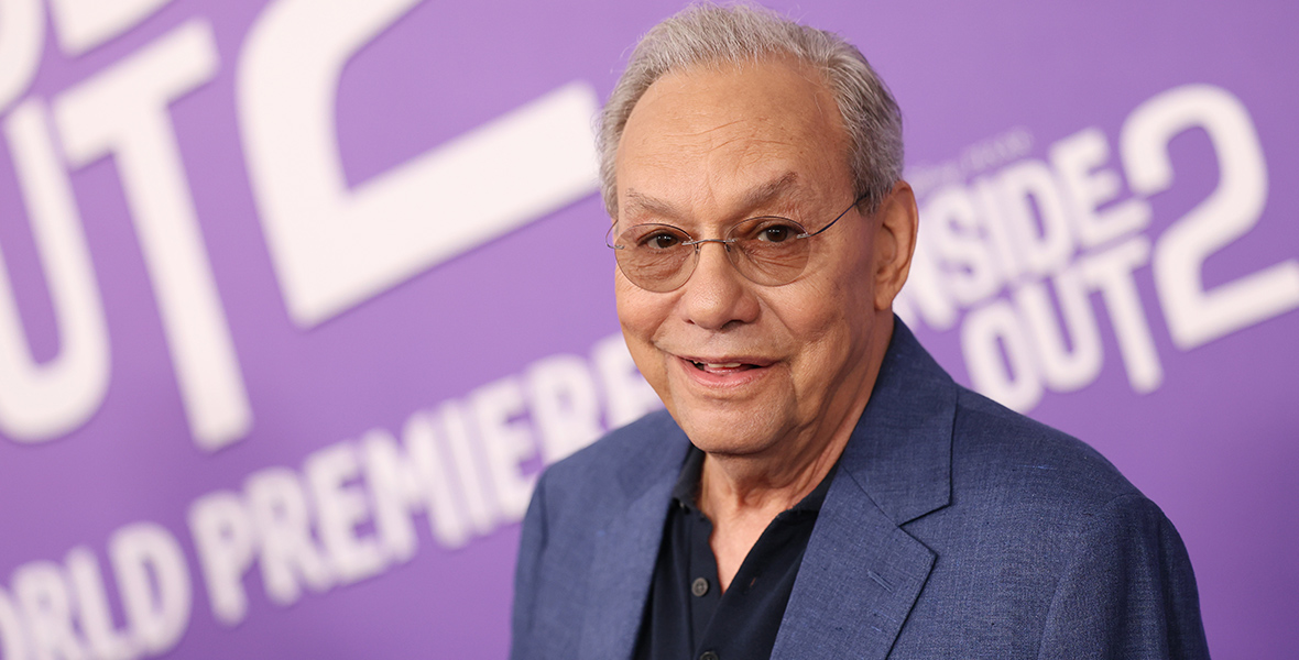 Inside Out 2 cast member Lewis Black stands in front of a backdrop with the film’s logo on it in white on purple at the film’s world premiere at the El Capitan Theatre in Hollywood, California, on June 10. He’s wearing a blue sport jacket over a black T-shirt.