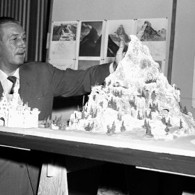 Walt Disney looks at the Matterhorn model.