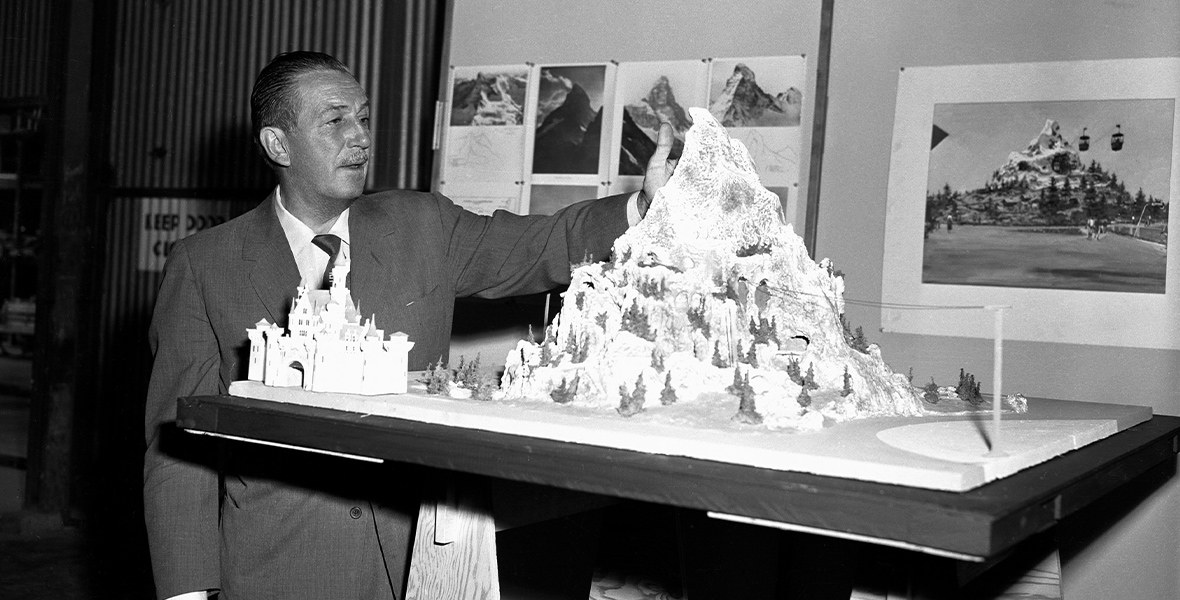 Walt Disney looks at the Matterhorn model.