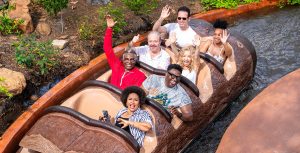 The Princess and the Frog cast members Bruno Campos, Keith David, Jennifer Cody, Anika Noni Rose, Jenifer Lewis, Michael-Leon Wooley, and Jim Cummings stand in front of Tiana's Bayou Adventure inside Magic Kingdom Park at Walt Disney World Resort.