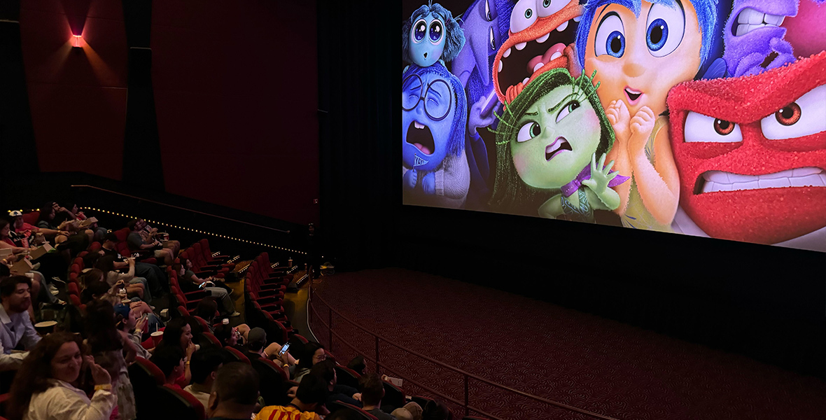 The Inside Out 2 logo appears on the screen as D23 Gold Member fans are in their movie theater seats, waiting for their early screening to begin.