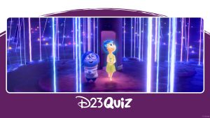 In a scene from Inside Out 2, Sadness (voiced by Phyllis Smith) and Joy (voiced by Amy Poehler) are standing on a dark blue island, surrounded by dark blue water. Neon-colored spheres with neon rays extending upward are scattered around the island and in the water. Behind Joy is a purple cylinder with a door-sized opening at its base. Both Joy and Sadness look upwards, amazed.