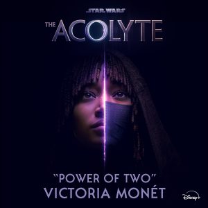 Image shows a promotional poster for the Star Wars series "The Acolyte." The poster features a close-up of a character's face, split down the middle by a glowing, purple light, symbolizing the "Power of Two." The character wears a dark hood and a mask. The title "The Acolyte" is at the top, with "Power of Two" by Victoria Mon&eacute;t displayed at the bottom, along with the Disney+ logo.