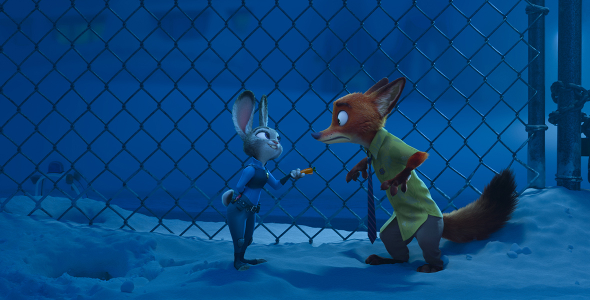 In an image from Zootopia, the fox Nick Wilde and the bunny Judy Hopps stand in the snow in front of a chain-linked fence. Judy is pointing her carrot-shaped pen in a shocked Nick’s direction.