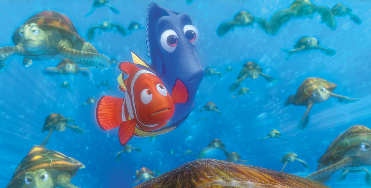 In an image from Finding Dory, Marlin and Dory hug while swimming amongst dozens of sea turtles.