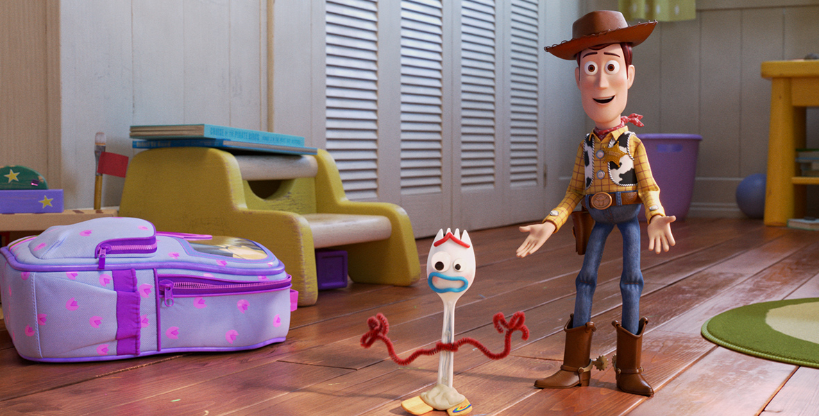 In an image from Toy Story 4, Forky (left) and Woody (right) stand next to each other in Bonnie’s room.