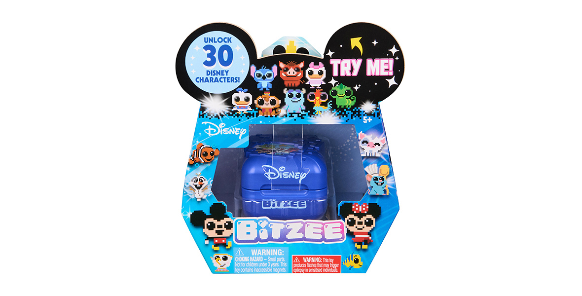 A Disney Bitzee toy package, featuring a blue electronic device with the Disney logo, housed in a box decorated with pixel art versions of various Disney characters. The top of the package includes black Mickey Mouse ears with text bubbles that read 'UNLOCK 30 DISNEY CHARACTERS!' and 'TRY ME!' in bright colors. The packaging showcases characters like Mickey Mouse, Minnie Mouse, and others in a pixelated design.