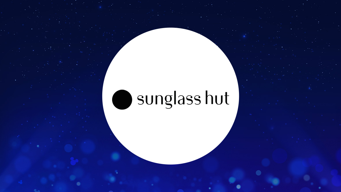 The image features a white circle centered against a deep blue background with small light effects and sparkling points, creating a magical atmosphere. Inside the circle, the text "sunglass hut" is written in black, lowercase letters. To the left of the text, there is a solid black circle, which is part of the logo design for Sunglass Hut.