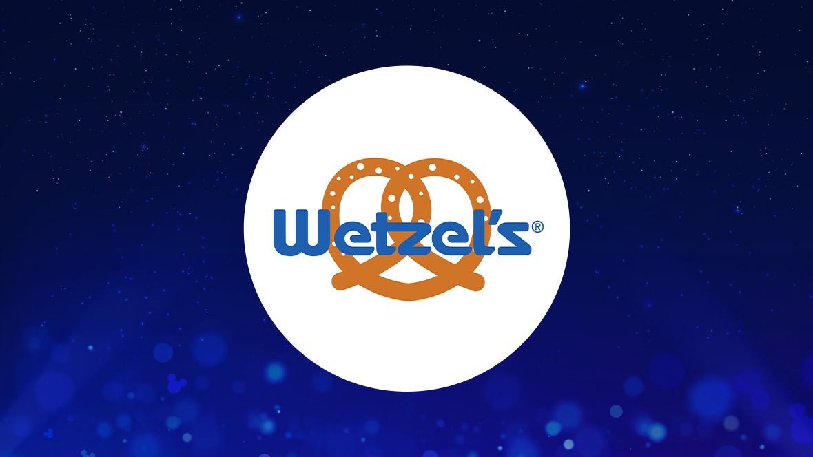 The image features a white circle centered against a deep blue background with small light effects and sparkling points, creating a magical atmosphere. Inside the circle, the text "Wetzel's" is written in a bold, blue font. The text is positioned over an image of an orange pretzel, which has small white dots representing salt.