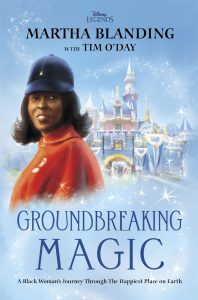 Book cover featuring an illustration of Martha Blanding wearing a red coat and blue hat, smiling against a background of Disneyland's Sleeping Beauty Castle. The title reads 'Groundbreaking Magic: A Black Woman's Journey Through The Happiest Place on Earth' by Martha Blanding with Tim O'Day. The background is filled with sparkling stars, adding a magical feel to the scene.