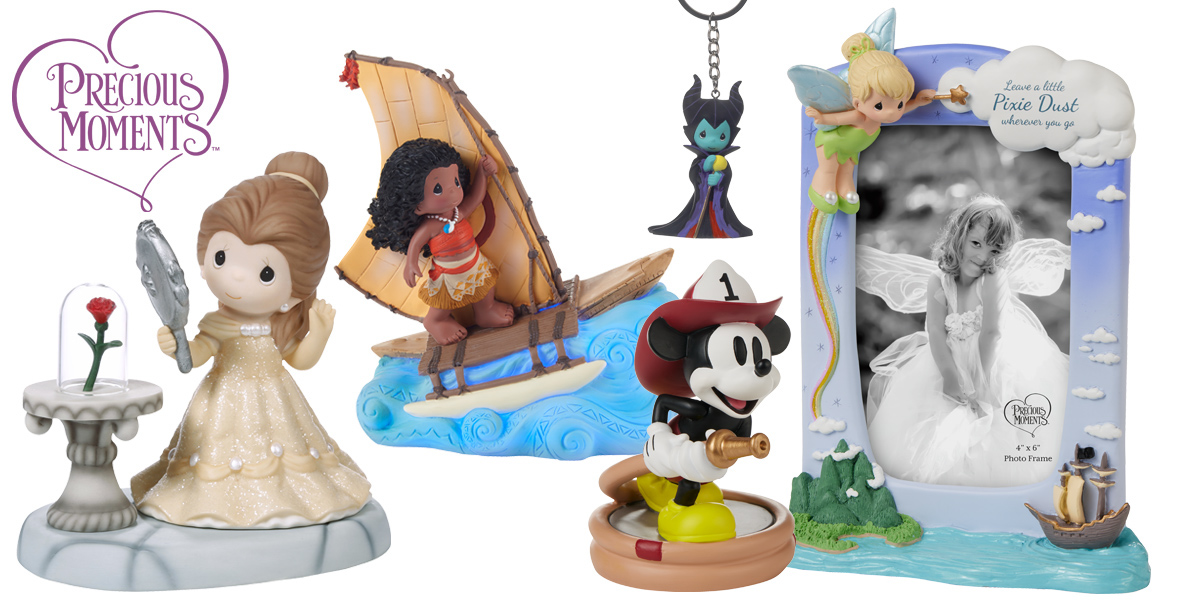 An assortment of Precious Moments figurines featuring Disney characters. From left to right: Belle from 'Beauty and the Beast' in a yellow gown holding a mirror with the enchanted rose in a glass dome on a table, Moana on her sailing boat with an ocean wave base, a Maleficent keychain, Mickey Mouse as a firefighter holding a hose, and a Tinker Bell-themed photo frame with Tinker Bell perched on top and a message that reads 'Leave a little Pixie Dust wherever you go.'