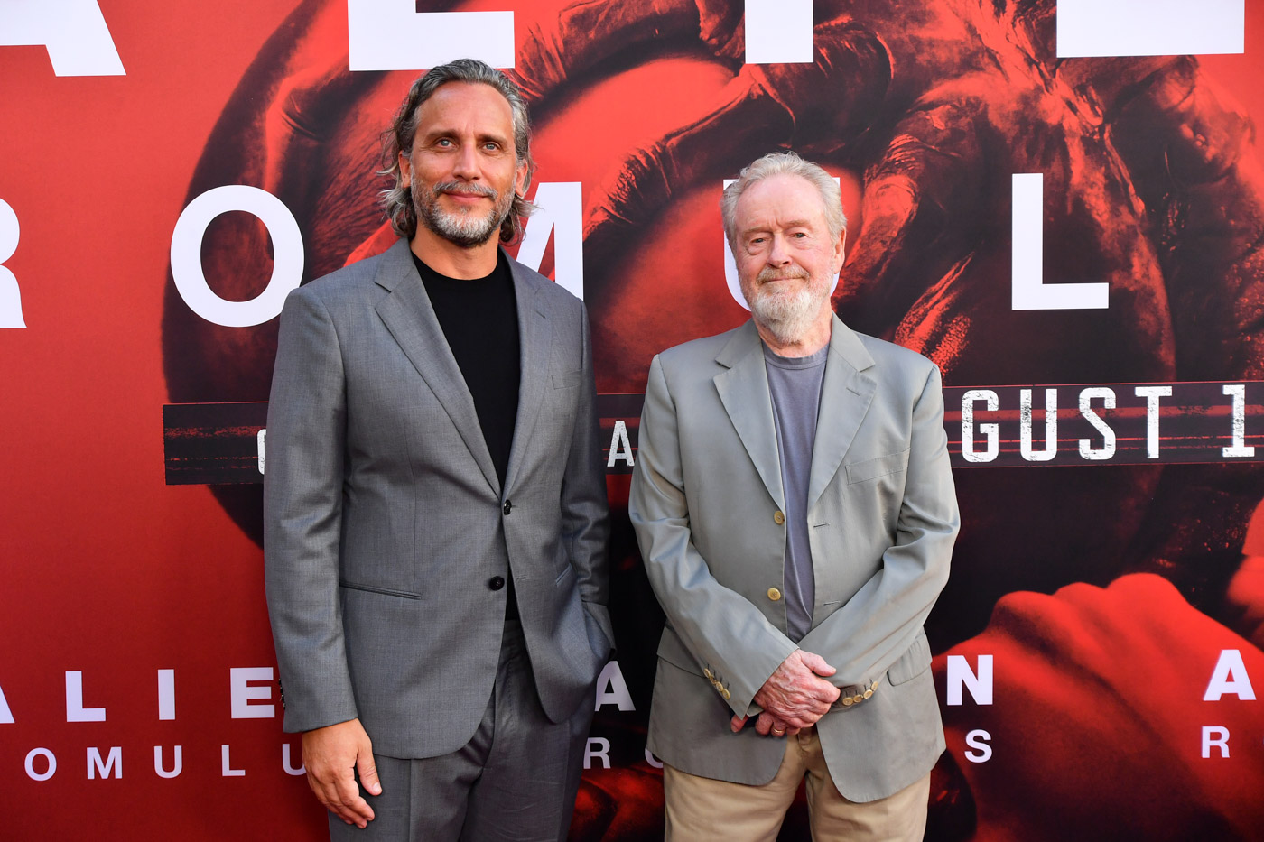 Director Fede Álvarez and producer Ridley Scott attend the Alien: Romulus world premiere at the TCL Chinese Theatre in Hollywood. Both men are wearing gray blazers.