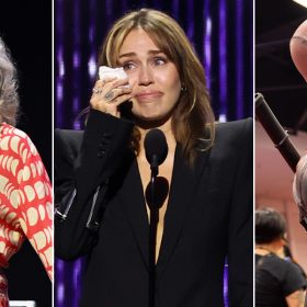 A collage of three images. On the left, Lesley Ann Warren, dressed in a red and white patterned outfit, smiles while on stage. In the center, Miley Cyrus is seen wiping away tears during an emotional moment while speaking at a podium. On the right, a person in a Deadpool costume poses with a playful expression, holding a finger to their mouth in a classic "shh" gesture.