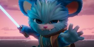 In a scene from &ldquo;Star Wars: Young Jedi Adventures,&rdquo; Nubs (a blue, furry member of the Poobian species voiced by Dee Bradley Baker) confidently faces the camera, ready for action. He is holding an activated lightsaber in his right hand. The background features a pink sky with pink clouds.