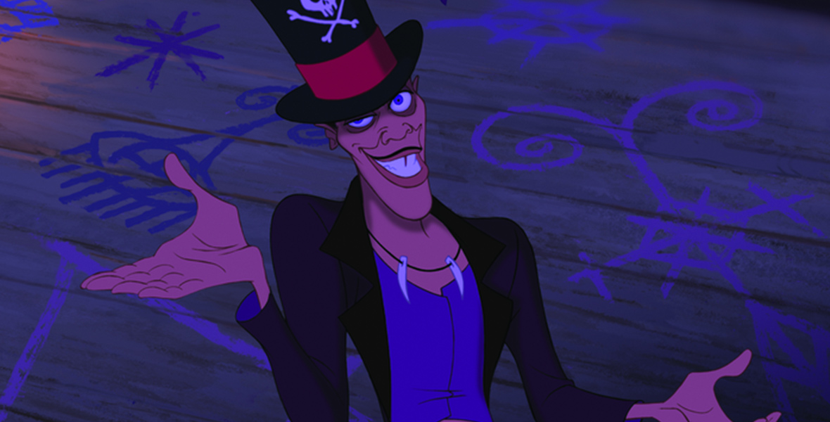 In a scene from The Princess and the Frog, Dr. Facilier (voiced by Keith David) is wearing a top hat adorned with a skull and crossbones and a red band. His expression is mischievous, with a sly grin, and he holds his arms out wide, surrounded by glowing purple symbols and shadows that evoke dark magic and voodoo powers.