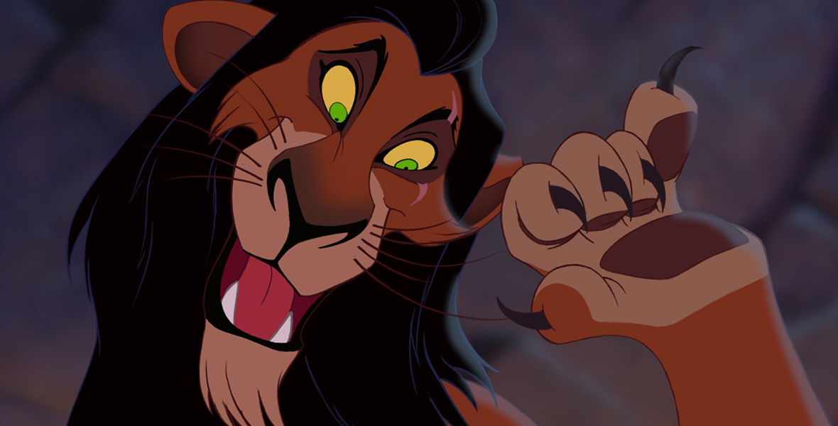 In a scene from The Lion King (1994), Scar (voiced by Jeremy Irons), a lion, has a sinister and mocking expression, as he raises his left paw, curling his claws in a casual yet threatening manner. His fur is a mix of browns and black, and his eyes are bright yellow and green.