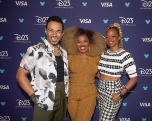 Corbin Bleu, Dara Reneé, and Monique Coleman from the High School Musical franchise pose backstage before the “Stay Tuned: You’re Watching Disney Channel” panel at D23: The Ultimate Disney Fan Event.