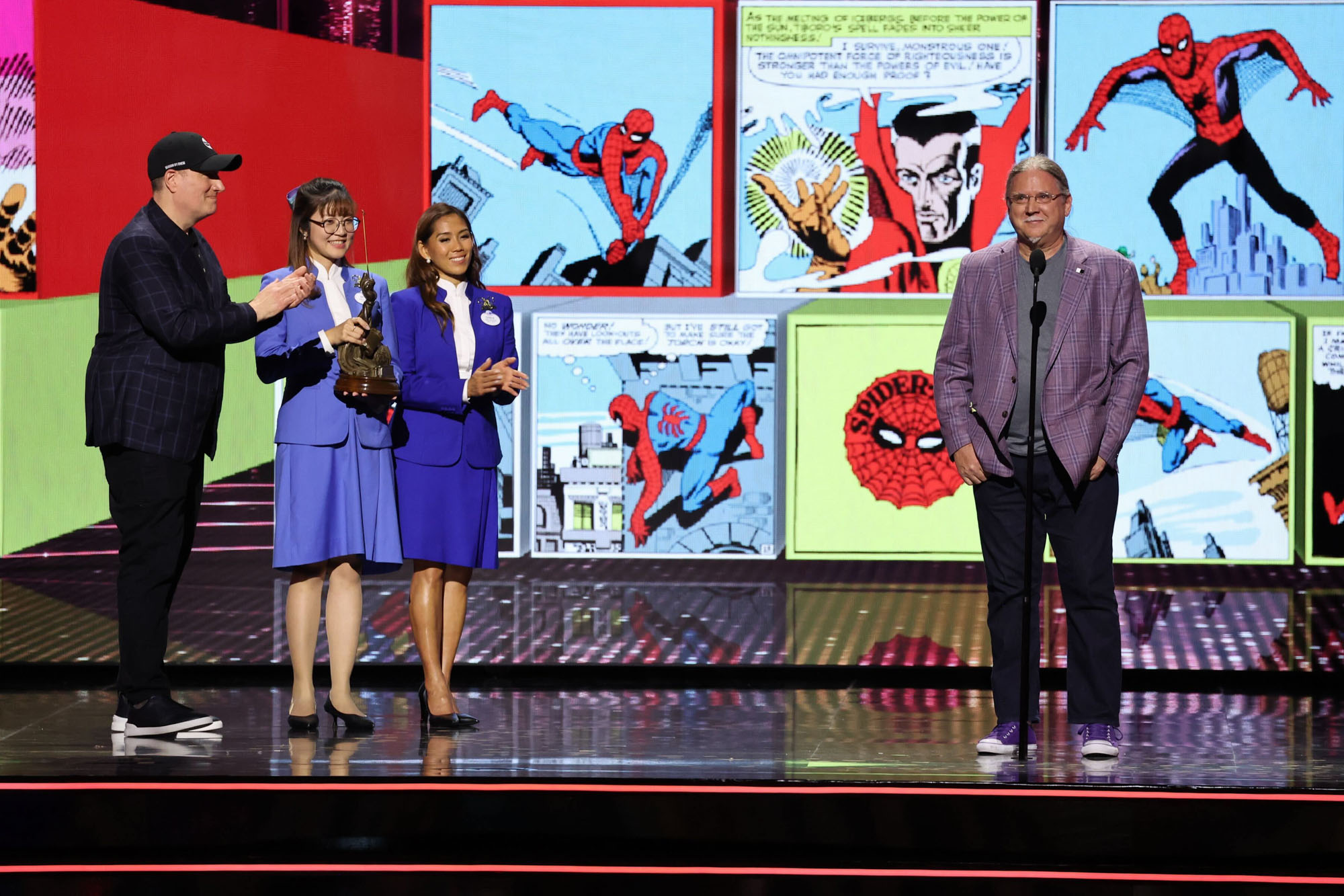 Steve Ditko’s nephew, Mark Ditko, appears centerstage at the Disney Legends Awards ceremony at the Honda Center in Anaheim, California, as part of D23: The Ultimate Disney Fan Event. At the far left is Marvel Studios president Kevin Fiege.