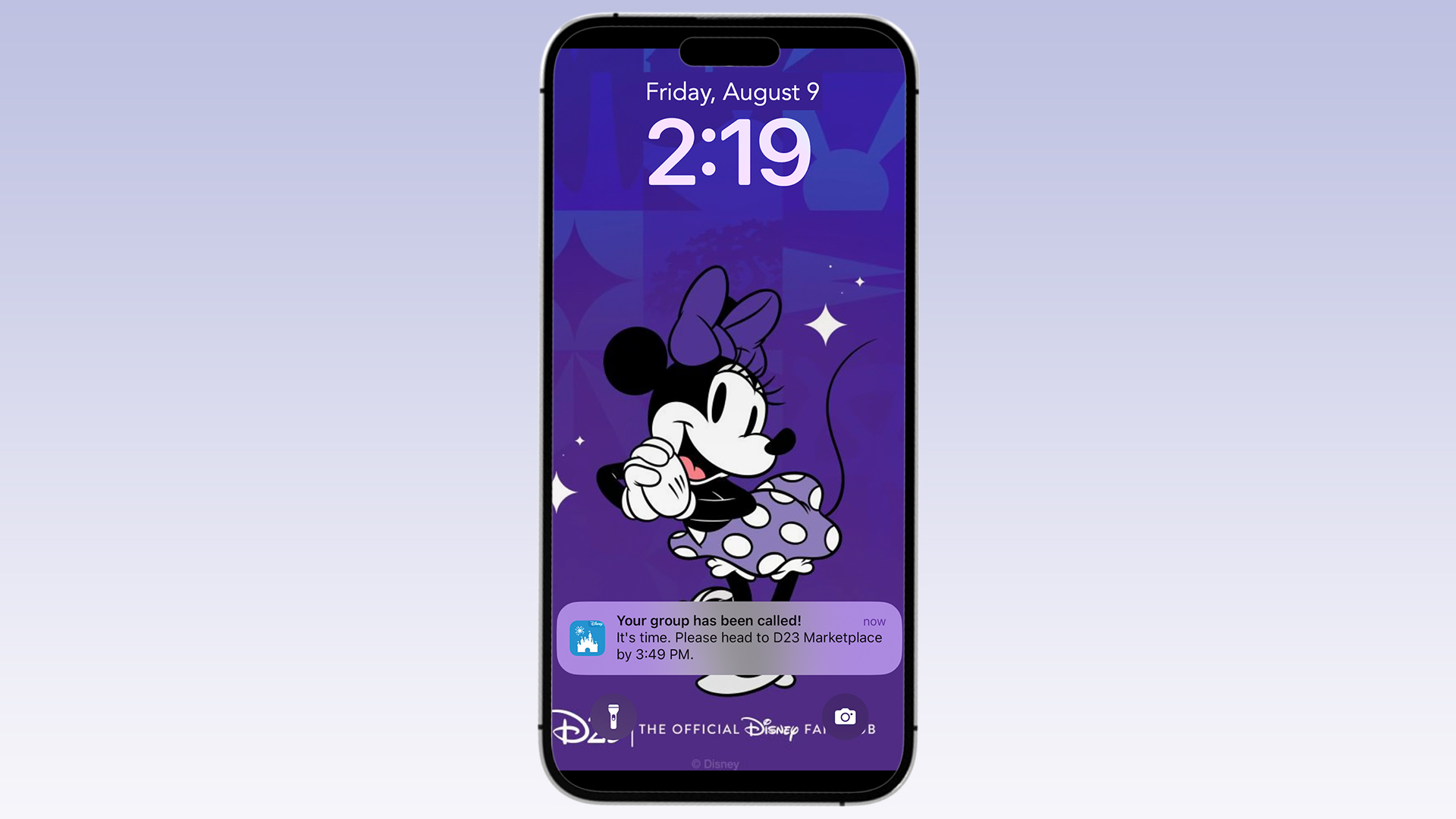 A screenshot of a mobile phone lock screen with a background image of Minnie Mouse. The time displayed is 2:19 on Friday, August 9. A notification from the Disneyland app states, "Your group has been called! It's time. Please head to D23 Marketplace by 3:49 PM." The lock screen also includes a flashlight and camera icon at the bottom.