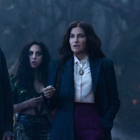 In a scene from Agatha All Along, (from left to right), Teen (Joe Locke), The Green Witch/Rio Vidal (Aubrey Plaza), Agatha Harkness (Kathryn Hahn), and Jennifer Kale (Sasheer Zamata) are standing together in a dark, foggy forest.