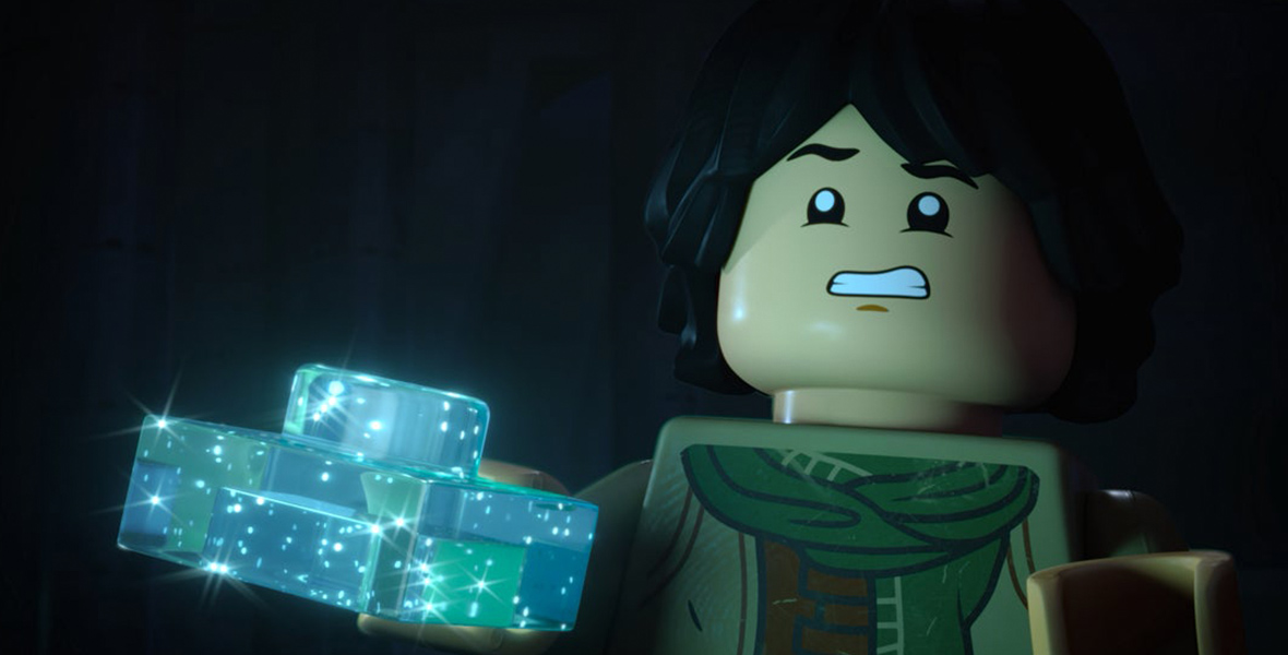 In a scene from LEGO Star Wars: Rebuilding the Galaxy, Sig Greebling (voiced by Gaten Matarazzo) holds a translucent, shimmery, light-blue LEGO piece with his right hand while appearing frightened.