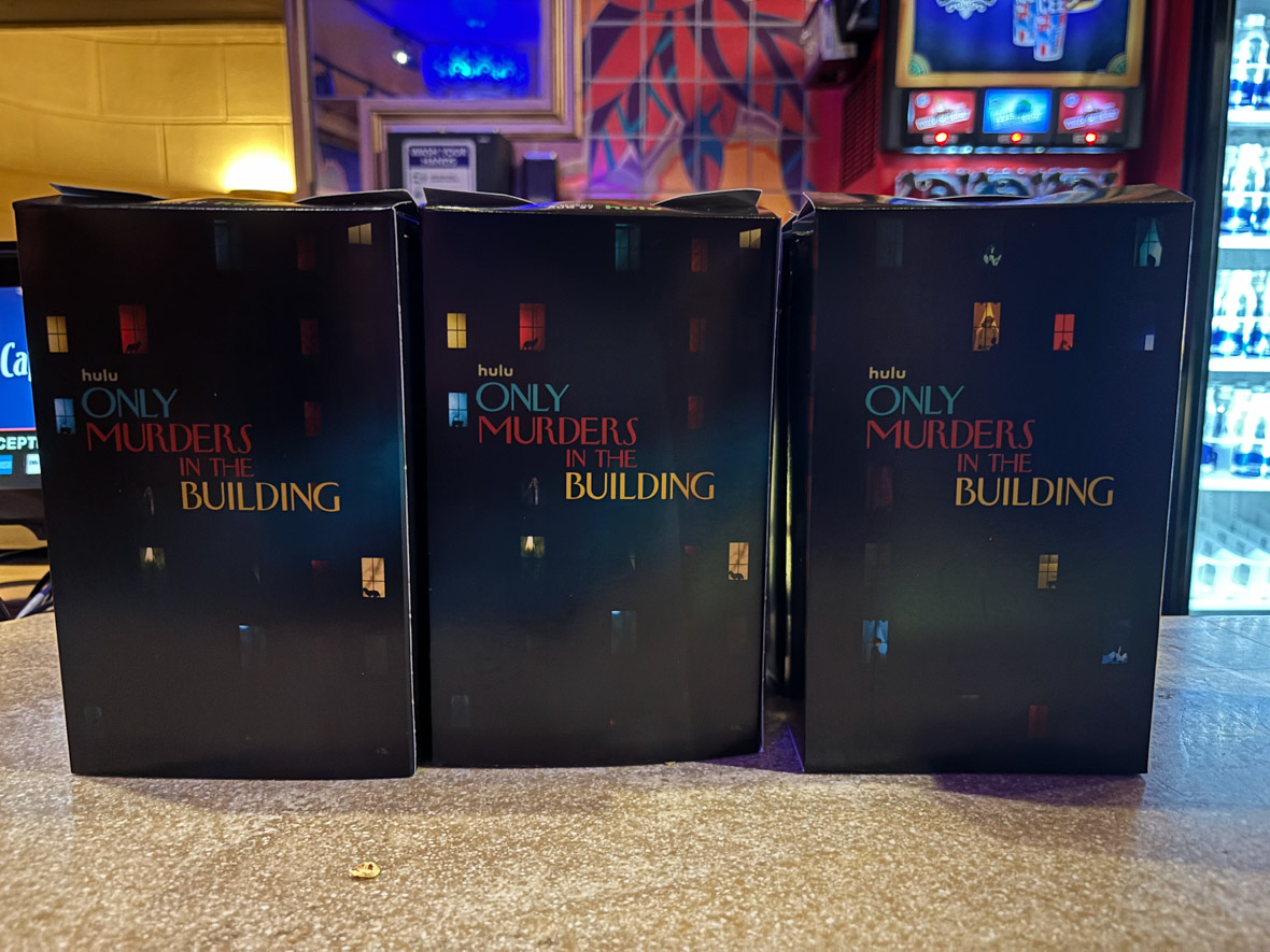 Three Only Murders in the Building-themed popcorn boxes.