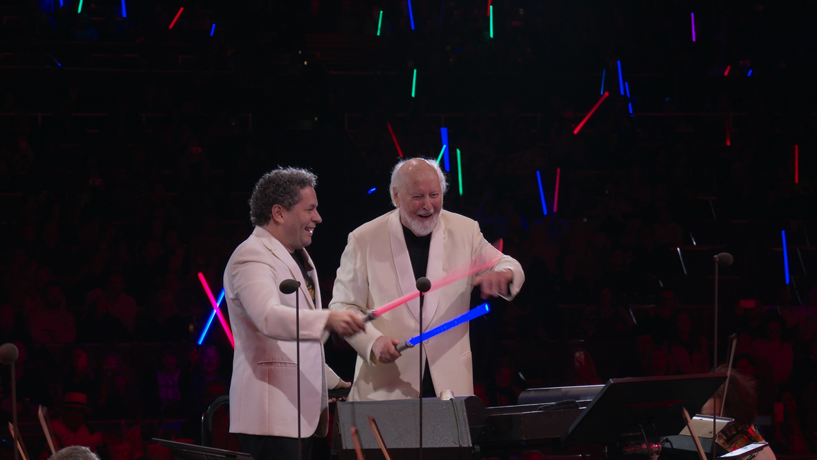 Gustavo Dudamel, Music & Artistic Director of the Los Angeles Philharmonic, conducts an orchestra—using a lightsaber—with John Williams at The Hollywood Bowl.