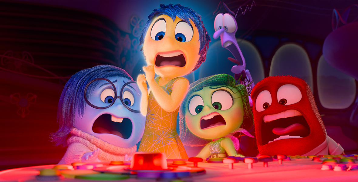 In an image from Disney and Pixar’s Inside Out 2, Sadness, Joy, Disgust, Fear, and Anger—all with shocked faces—huddle together around their control panel.