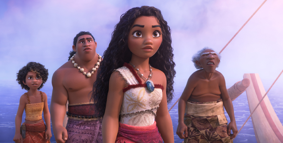 In an image from Walt Disney Animation Studios’ Moana 2, from left to right, Loto (voiced by Rose Matafeo), Moni (voiced by Hualālai Chung), Moana (voiced by Auli‘i Cravalho), and Kele (voiced by David Fane) are standing on a canoe in the middle of the ocean, looking at something off-camera to the right.