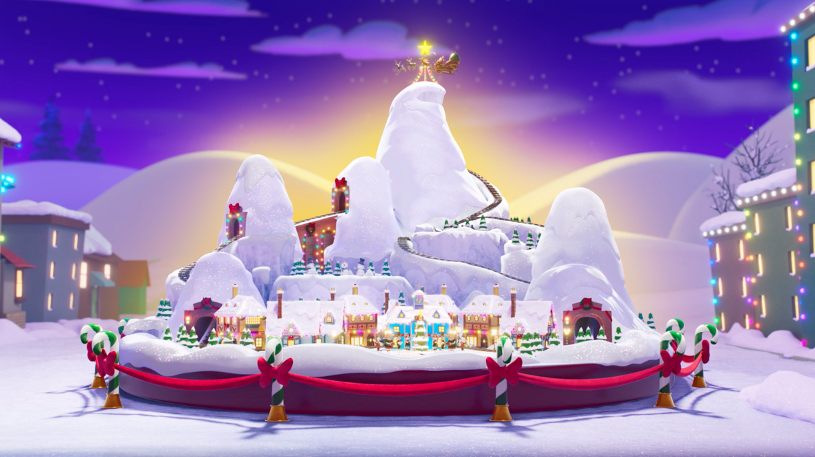 A scene from Mickey and the Very Many Christmases showcases the Wonderland Mini, a model mountain village filled with festive decorations, including lit-up houses, bows, and Christmas trees. The background depicts snow-covered mountain peaks under a dark, cloudy night sky dotted with stars.