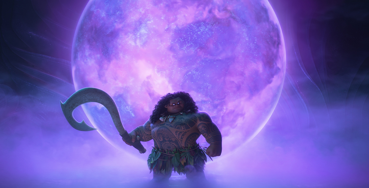 In an image from Walt Disney Animation Studios’ Moana 2, Maui (voiced by Dwayne Johnson) is standing in front of stylized moon, seen in luminescent hues of purple and blue, and he looks off camera to the right. He’s surrounded by mist and is holding his magical hook.