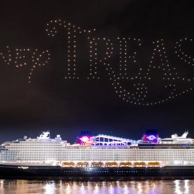 Drones spell the word Disney Treasure above the new cruise ship.