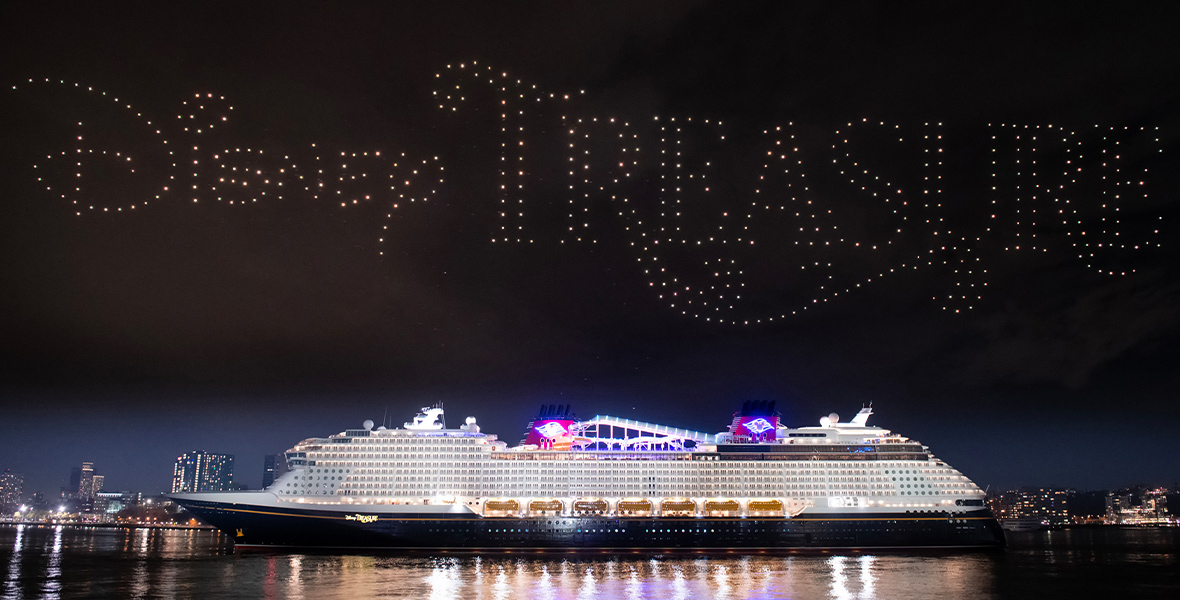 Drones spell the word Disney Treasure above the new cruise ship.