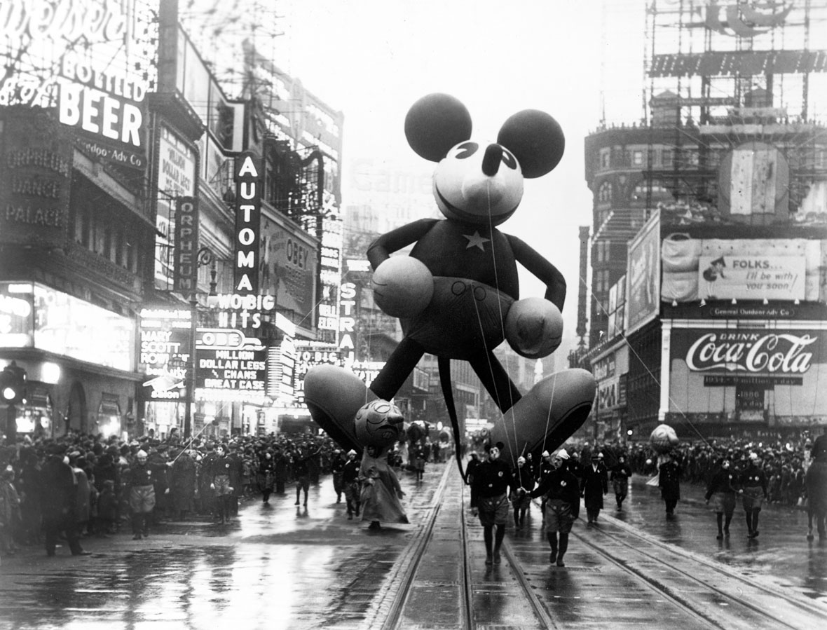 The original Mickey Mouse balloon in the Macy’s Thanksgiving Day Parade in 1934 is seen at center of this black-and-white image as it makes its way down the parade route. 