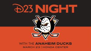 In an image promoting D23 Night with the Anaheim Ducks, the upper half of the image contains large orange text—on a black background—which reads “D23 Night”; the lower half of the image contains black text—on an orange background—which reads “With the Anaheim Ducks, March 23, Honda Center.” The Anaheim Ducks logo, a duck-shaped hockey mask against two orange hockey sticks, is seen at center.