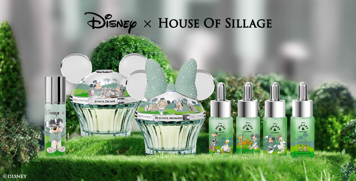 An array of bottles, some small and others large adorned with Mickey and Minnie Mouse ears from House of Sillage’s Mickey & Friends Collection are displayed on an evergreen mantle.