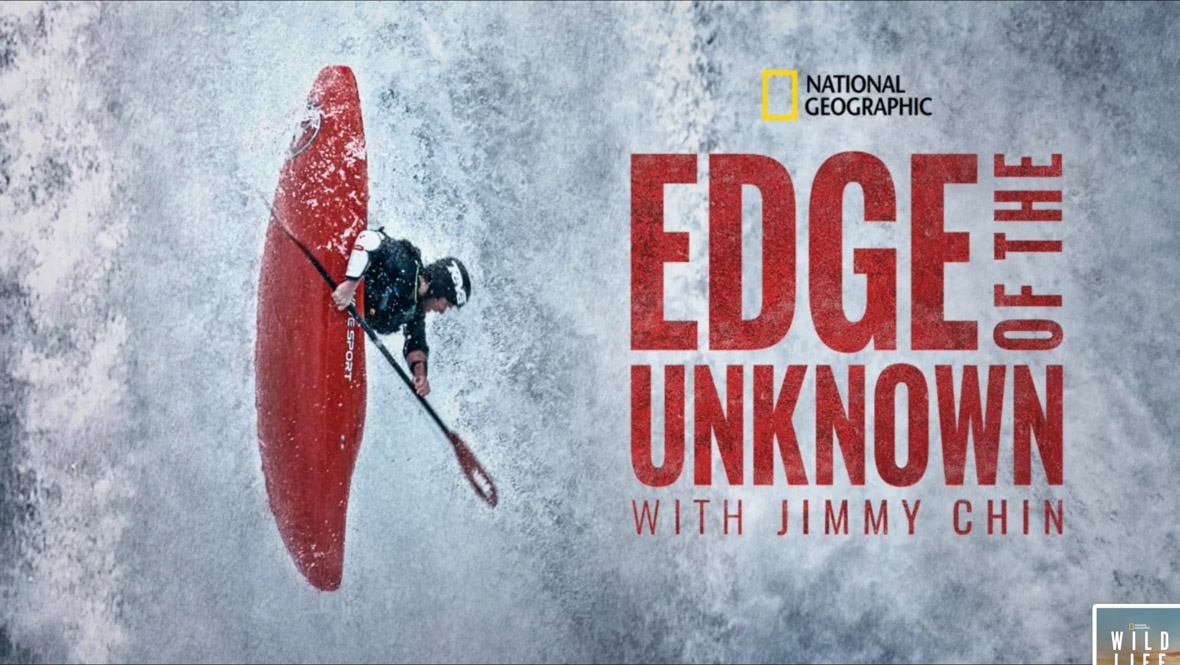 A key art image for the National Geographic series Edge of the Unknown with Jimmy Chin. To the left, a kayaker is completely vertical in their kayak, traveling down rushing water, holding onto their oar. To the left, set against the rushing water background, is the National Geographic logo and the title of the series.