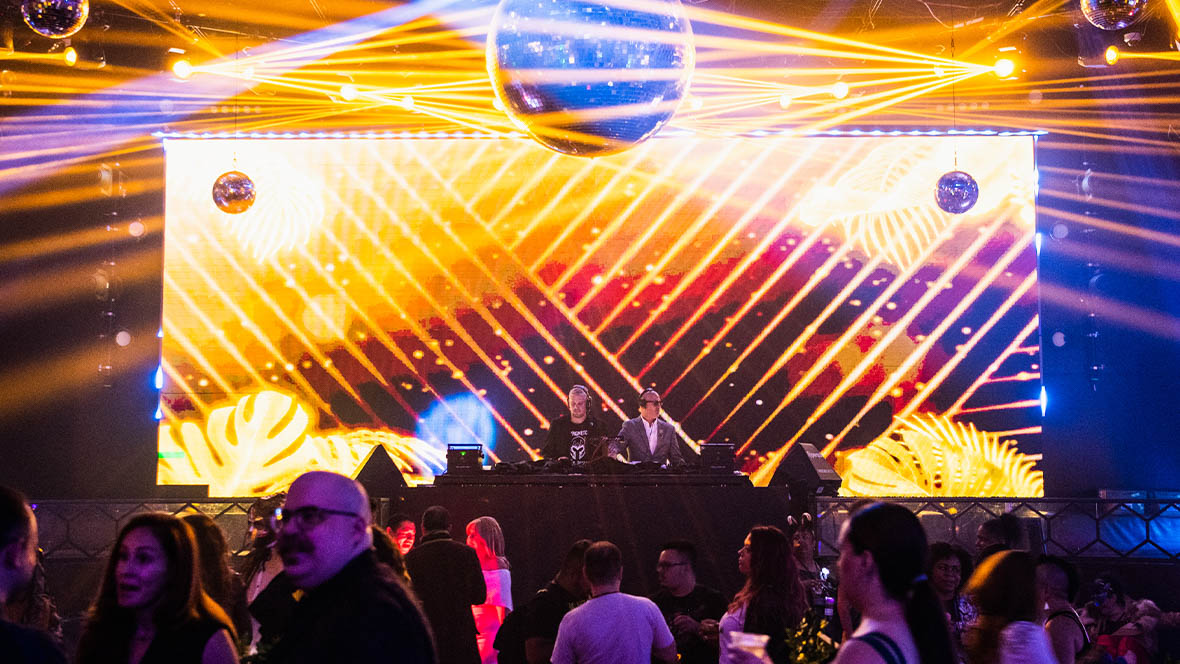 A brightly-lit and filled dance floor at a D23 event.