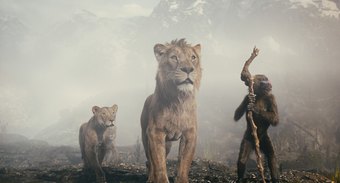 (L-R): Sarabi (voiced by Tiffany Boone), Taka (voiced by Kelvin Harrison Jr.), Mufasa (voiced by Aaron Pierre), and Rafiki (voiced by Kagiso Lediga) stand surveying something unseen in the distance with a misty snow-dappled mountain in the background. 