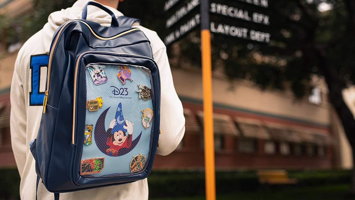 Man wearing a D23: The Ultimate Disney Fan Event exclusive backpack at the Walt Disney Studio Lot.