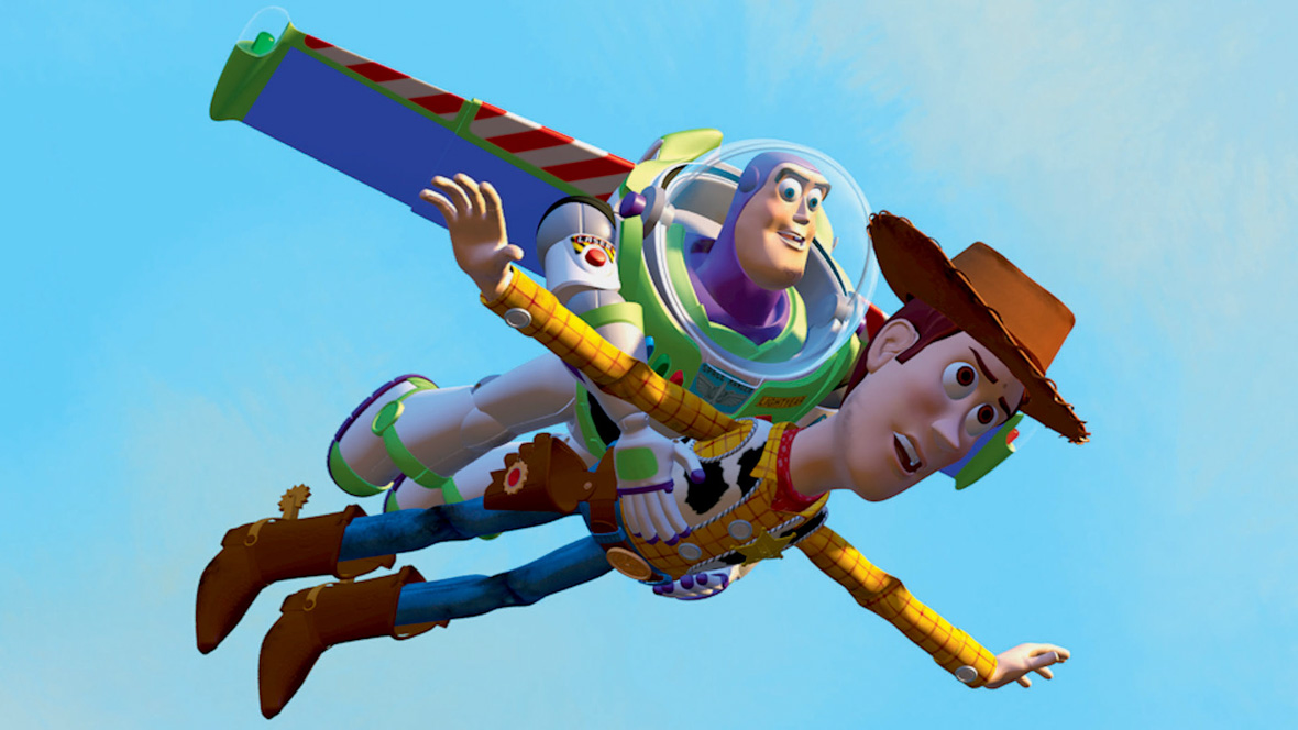 In an image from Toy Story, Buzz Lightyear (a live-action toy), voiced by Tim Allen, flies in the air holding Woody (a cowboy toy), voiced by Tom Hanks.