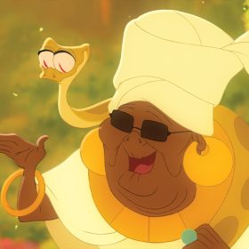 Mama Odie from The Princess in the Frog smiling with her snake, Juju, riding on her shoulders.